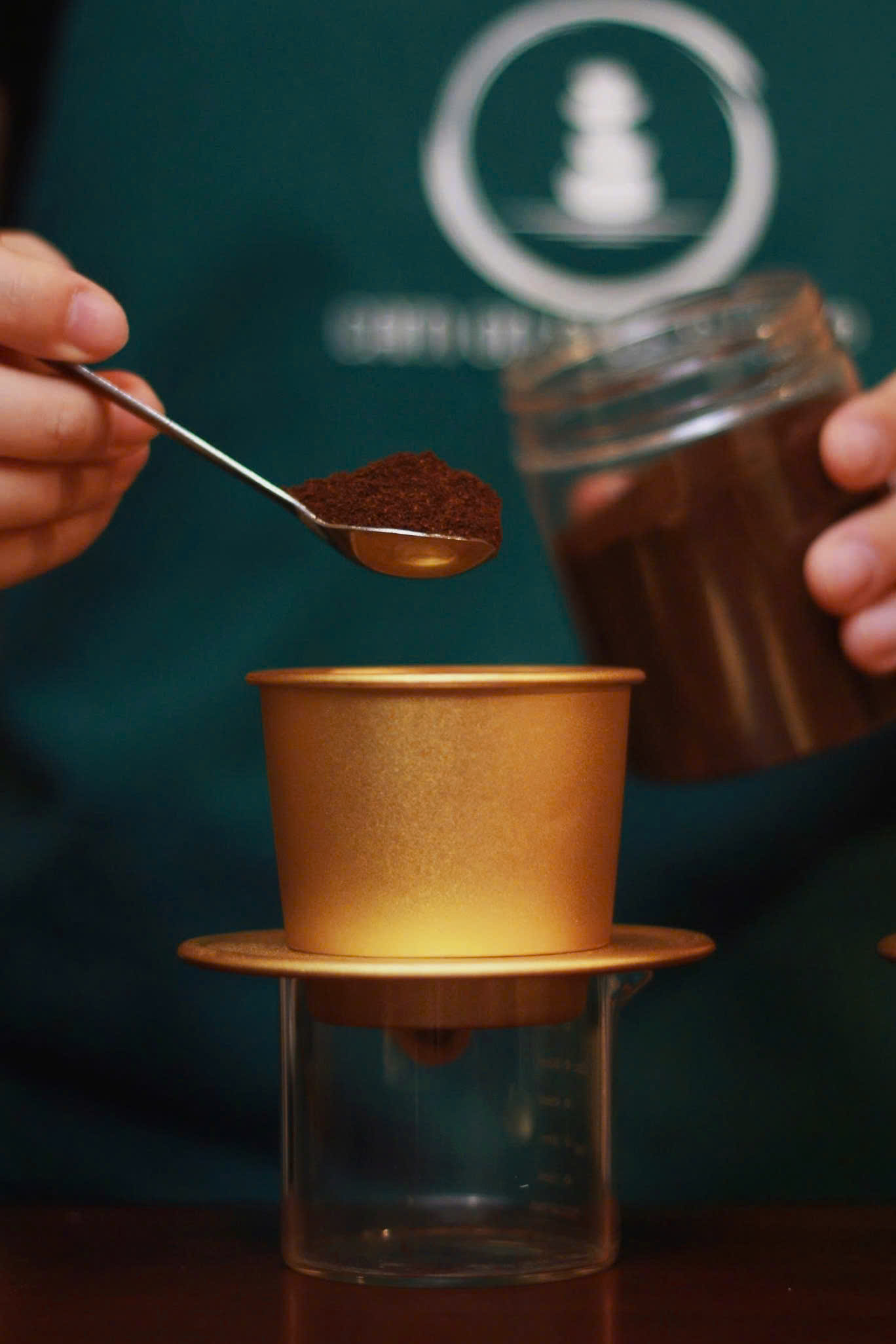 Step 1: Adding coffee grounds to a phin